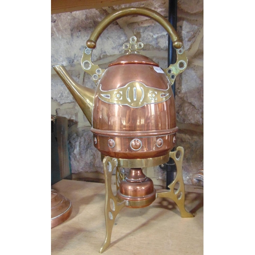 1407 - A good copper and brass spirit kettle in the arts and crafts manner, together with a further copper ... 