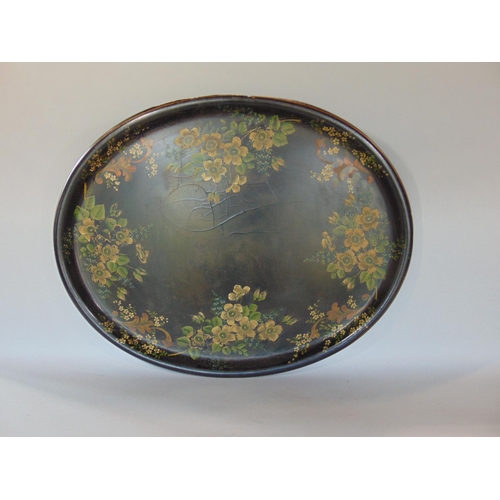 1436 - Large Victorian oval tray painted with various country flowers upon a black ground, 77 cm long (AF)