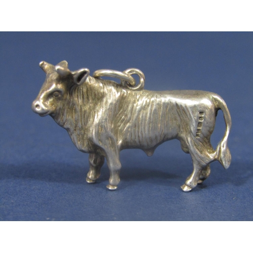 835 - Cast silver pendant or charm in the form of a standing bull, 3.5cm long