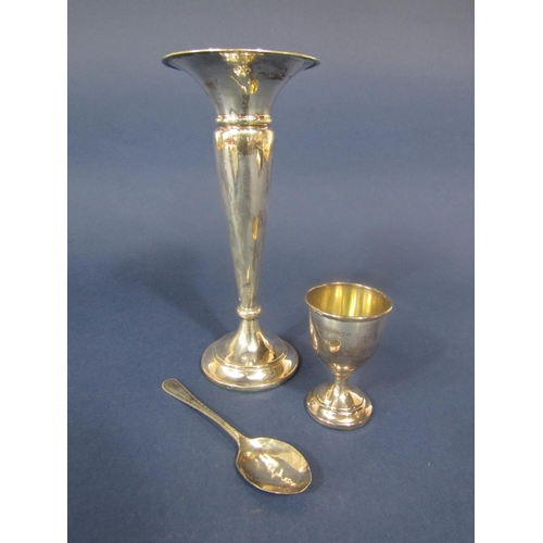 843 - A collection of silver comprising a silver eggcup and spoon, flared vase and small thimble (4)