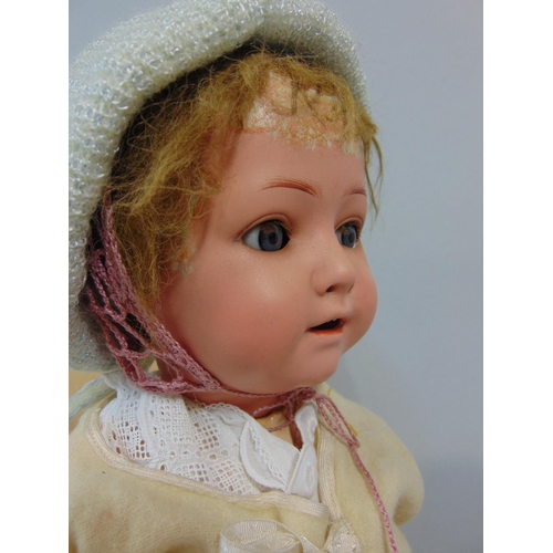 1245 - A Heubach Koppelsdorf 320 character baby doll C1920 with bisque head,blue sleeping eyes, jointed ben... 