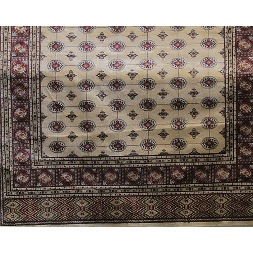 2419 - Traditional Cashmere Bokhara design carpet, with red geometric typical decoration upon an ivory grou... 