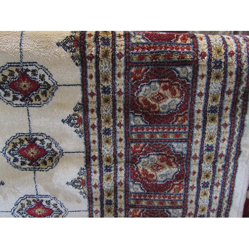 2419 - Traditional Cashmere Bokhara design carpet, with red geometric typical decoration upon an ivory grou... 