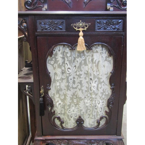 1870 - An Edwardian mahogany side cabinet with raised and shaped back enclosing a bevelled edge shield shap... 