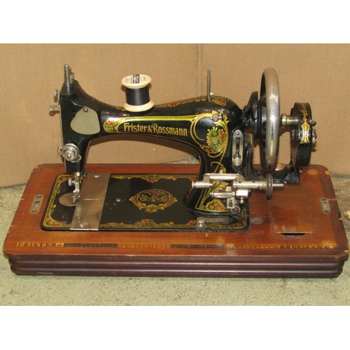 1875 - A vintage Frister and Rossmann walnut cased portable sewing machine together with a small wicker sew... 