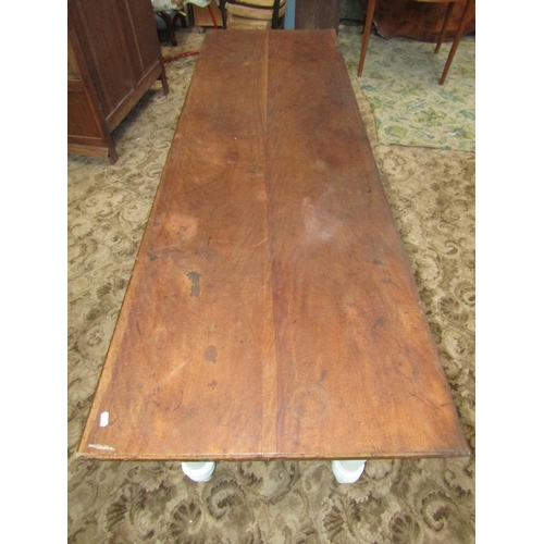 1884 - A Victorian and possibly later farmhouse kitchen table, the rectangular mahogany top raised on later... 