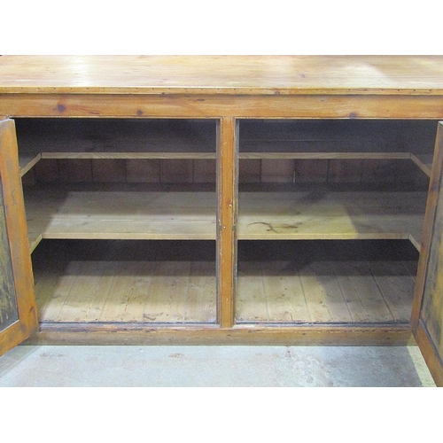 1896 - A large rustic pine floorstanding kitchen side cupboard/unit enclosed by a pair of rectangular panel... 