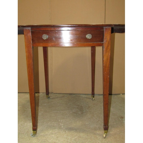 1899 - A small 19th century mahogany Pembroke table with oval drop leaves, with one real and one dummy frie... 