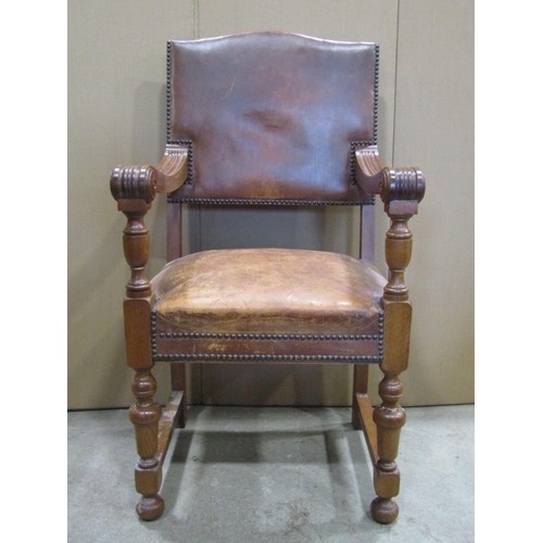 1907 - A set of six (4+2) oak framed dining chairs, loosely in the Cromwellian style with worn tan leather ... 