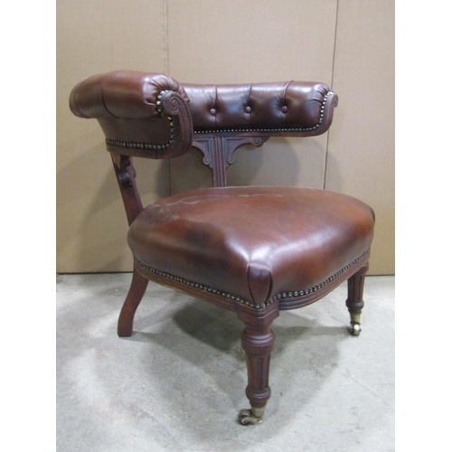 1910 - A Victorian oak library chair with recently re-upholstered brown leather seat and buttoned horseshoe... 