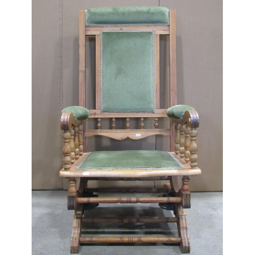 1915 - An Edwardian rocking chair, with moulded frame, upholstered pad seat, back and arms