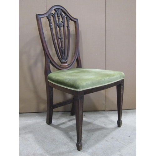 1920 - A pair of late Victorian mahogany dining chairs in the Hepplewhite style with shield shaped and pier... 