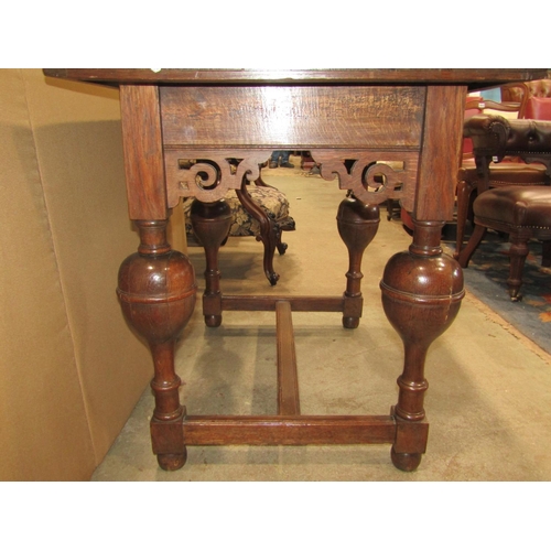 1923 - A Dutch style oak centre table, the rectangular plank top raised on four bulbous supports united by ... 