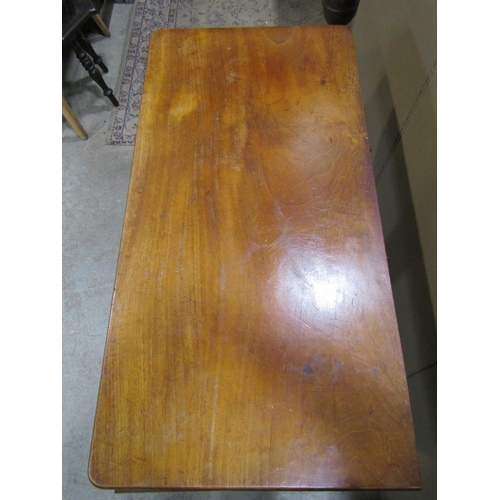 1924 - A Victorian mahogany fold over top tea table, with moulded scrolled frieze, raised on a central octa... 