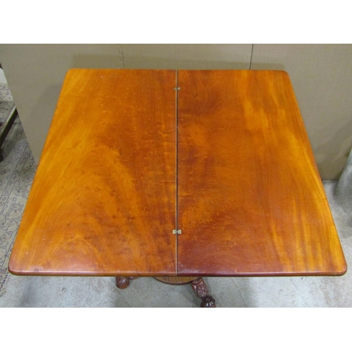 1924 - A Victorian mahogany fold over top tea table, with moulded scrolled frieze, raised on a central octa... 