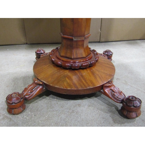 1924 - A Victorian mahogany fold over top tea table, with moulded scrolled frieze, raised on a central octa... 