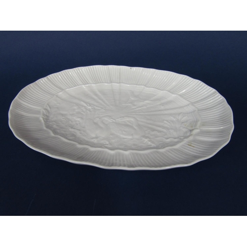 662 - A 19th century Meissen type white glaze dish of oval form with relief decoration of a pair of swans ... 