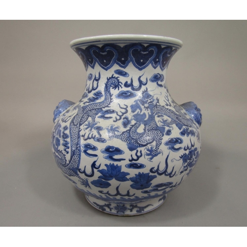 665 - A 19th century oriental vase with blue and white painted dragon and flaming pearl detail and moulded... 