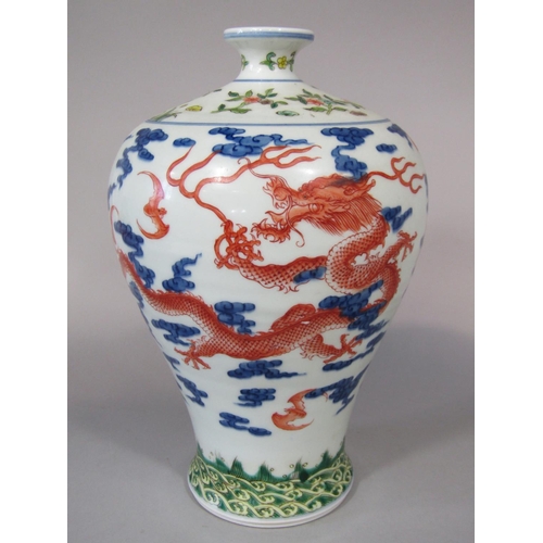 672 - An oriental vase of shouldered form with polychrome painted dragon, bat and cloud decoration, with b... 