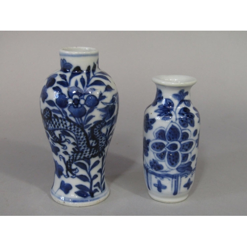 678 - A small oriental blue and white vase of shouldered form with dragon and flowering plant decoration, ... 