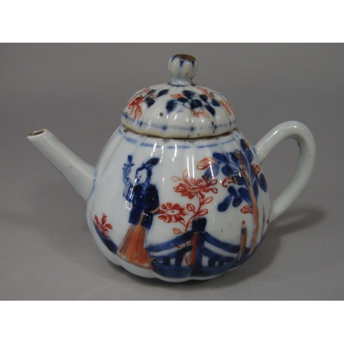 687 - An 18th century oriental tea pot and cover of globular form with famille rose painted bird and flora... 