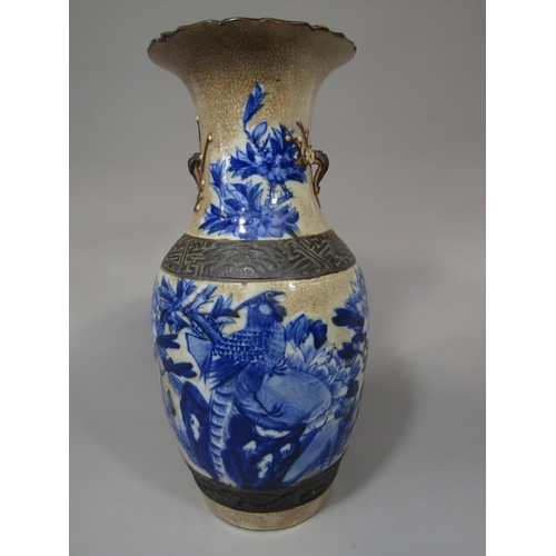 692 - A 19th century oriental vase with crackle glaze detail, blue and white painted pheasant a flowering ... 