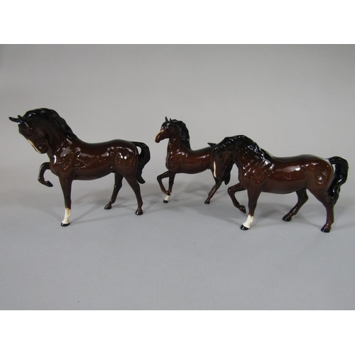 701 - Three Beswick brown glazed horses, each with raised foreleg (3)