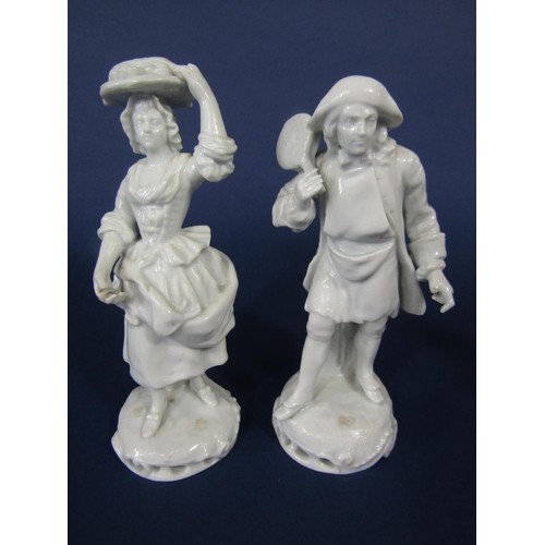 702 - A set of four late 19th century white glazed Neapolitan figures of street vendors all with blue crow... 