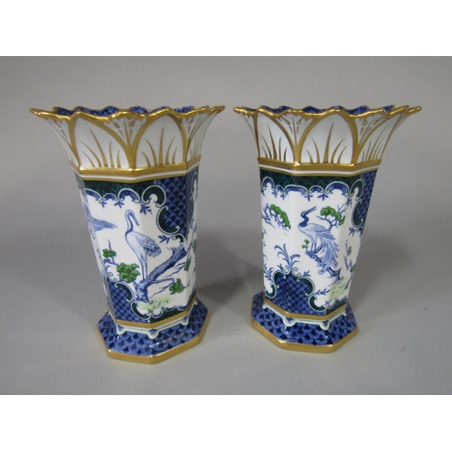 710 - A pair of Royal Crown Derby vases of octagonal form with flared rims and blue and green exotic bird ... 