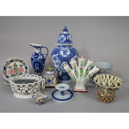 721 - A collection of tin glazed earthenwares including a blue and white vase and cover with floral decora... 