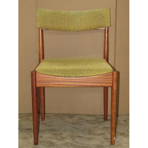 1936 - A set of four mid-20th century teak framed dining chairs with light green upholstered drop-in seats ... 