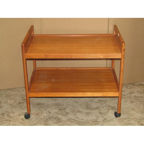 1937 - A long and low retro teak sideboard, partially enclosed by three doors and a tower of three drawers,... 