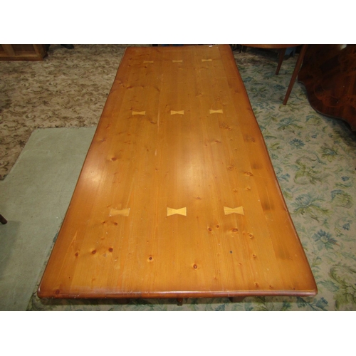 1953 - A pine kitchen table with rectangular top, raised on square cut and chamfered legs united by a centr... 