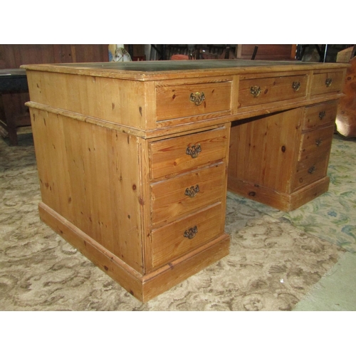 1957 - A stripped pine knee hole twin pedestal desk, with inset writing surface over an arrangement of nine... 