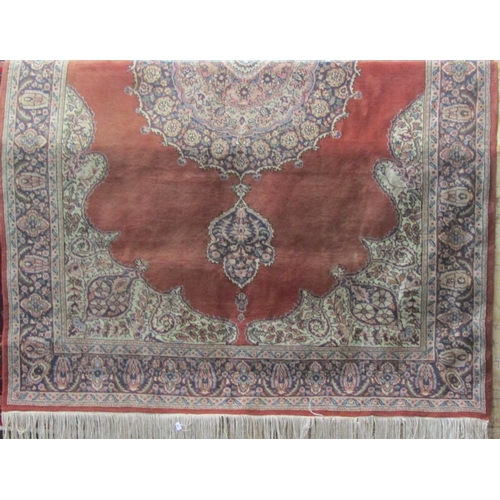 2373 - Full pile eastern carpet with central blue medallion upon a washed red ground, 320 x 210cm