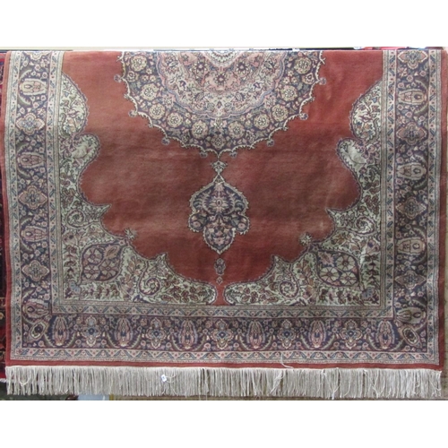 2373 - Full pile eastern carpet with central blue medallion upon a washed red ground, 320 x 210cm