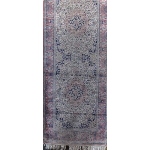 2374 - Cashmere type runner decorated with various floral medallions upon a pink ground, 300 x 80cm