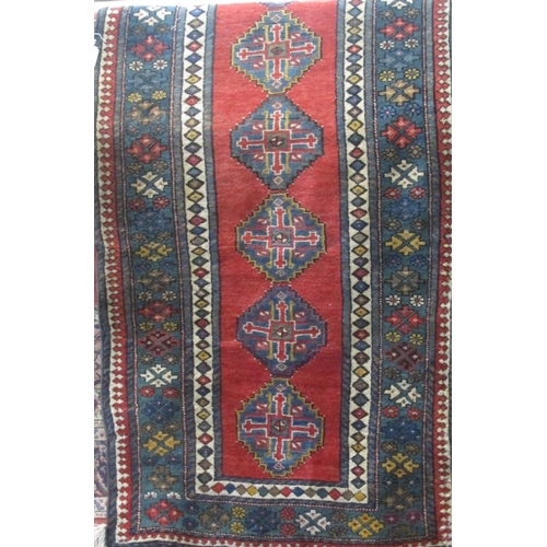 2375 - Good quality full pile runner with nine blue medallion upon a washed red ground, 280 x 170cm