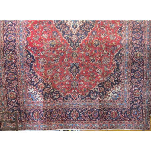 2382 - Good quality Hamadan type village Keshan carpet with scrolled floral decoration upon a red ground, 3... 