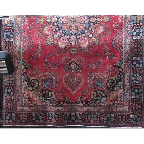 2383 - A Persian Mashad with various floral panels and medallions upon a light red ground, 270 x 180cm