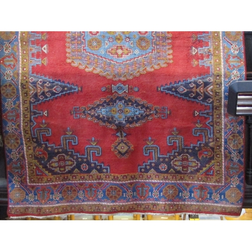 2386 - Full pile Persian village carpet with various blue and pink ,medallions upon a red ground, 310 x 200... 