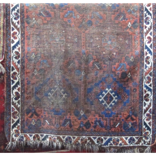 2387 - Antique well worn Persian rug with medallion decoration upon a brown ground, 150 x 110cm