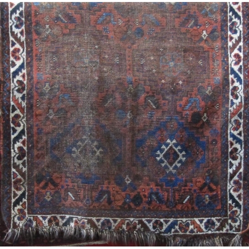 2387 - Antique well worn Persian rug with medallion decoration upon a brown ground, 150 x 110cm