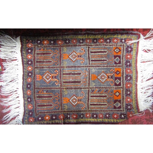 2388 - Two Afghan rugs with medallion decoration upon a red ground, the largest 215 x 130cm, together with ... 