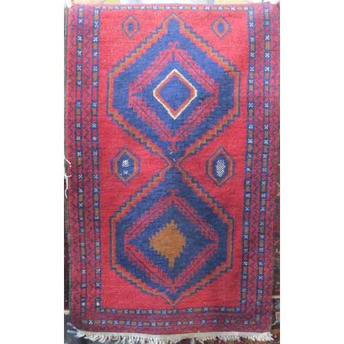 2388 - Two Afghan rugs with medallion decoration upon a red ground, the largest 215 x 130cm, together with ... 