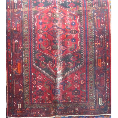 2388 - Two Afghan rugs with medallion decoration upon a red ground, the largest 215 x 130cm, together with ... 