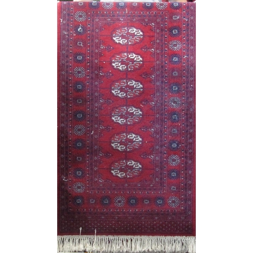 2390 - Pair of long Bokhara runners with typical geometric medallion decoration upon a red ground, each 330... 