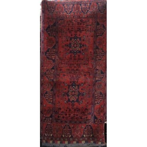 2395 - Good quality Persian rug with star, medallion and floral decoration upon a deep red ground, 160 x 75... 