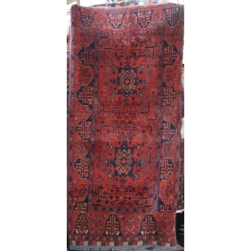 2395 - Good quality Persian rug with star, medallion and floral decoration upon a deep red ground, 160 x 75... 