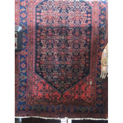 2406 - Persian rug with central blue geometric medallion decoration upon a washed pink ground, 230 x 135cm